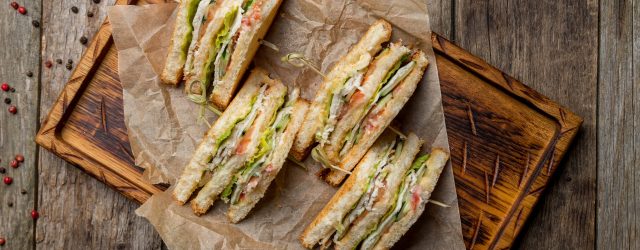 Club,Sandwich,With,Chicken,On,Wooden,Board